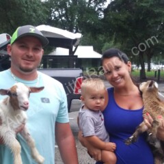 family with kids who have mini baby goats as pets